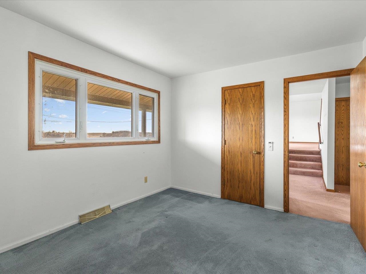 2110 East Angle Road Dakota, IL 61018 - Photo 23 of 47 an empty room with windows and closet