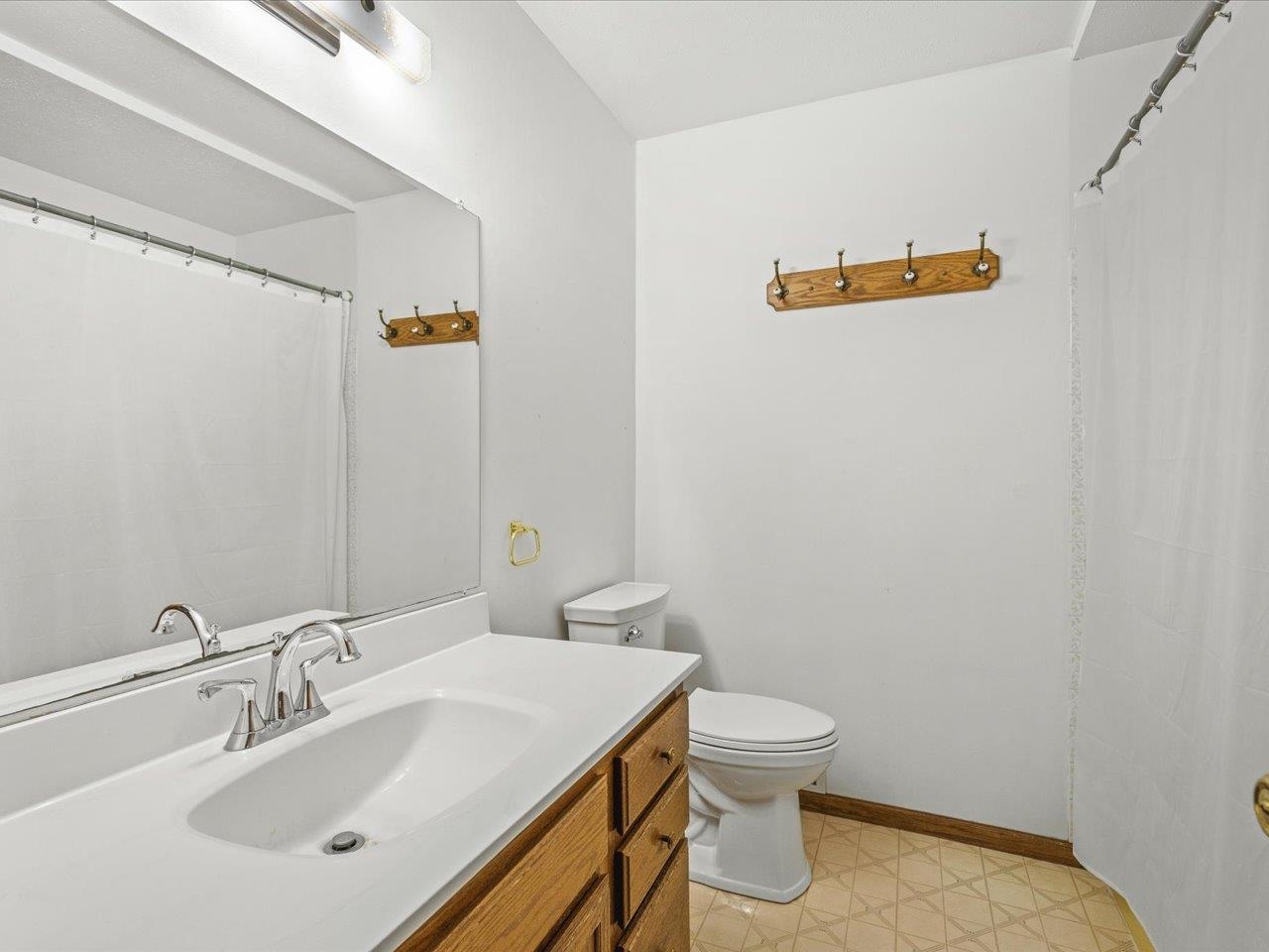 2110 East Angle Road Dakota, IL 61018 - Photo 30 of 47 a bathroom with a sink a toilet and a mirror