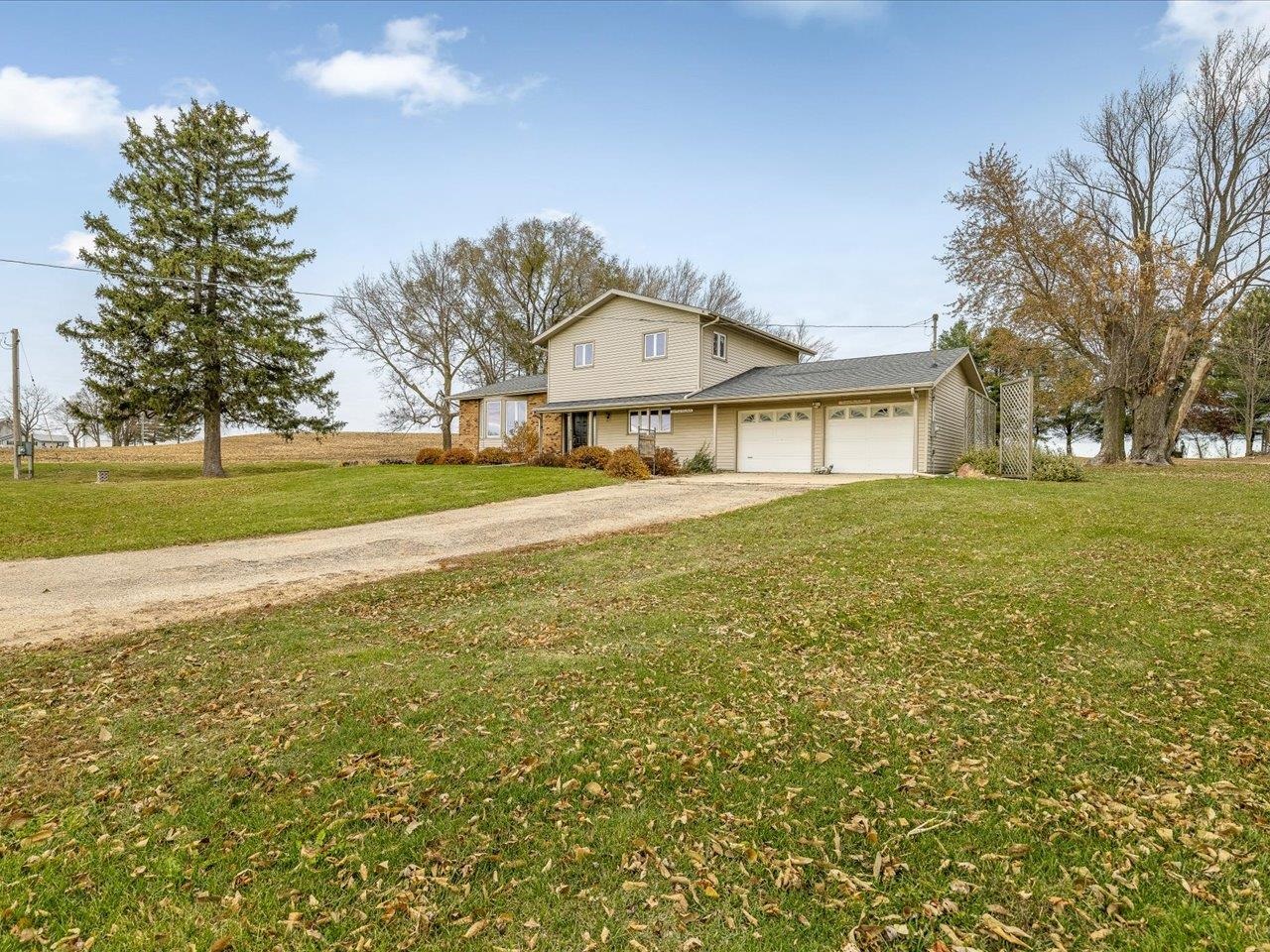 2110 East Angle Road Dakota, IL 61018 - Photo 3 of 47 a front view of a house with a yard and garage