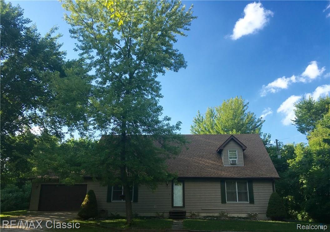 59468 Travis Road New Hudson, MI 48165 - Photo 1 of 13 Surrounded by beautiful, mature hardwoods