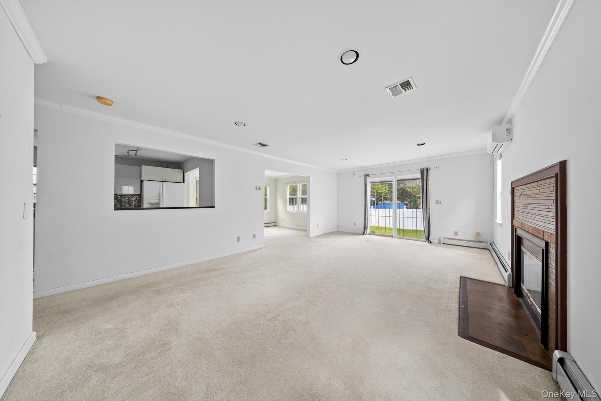 82 B Inwood Road Port Washington, NY 11050 - Photo 5 of 41 a big room with windows and a fireplace