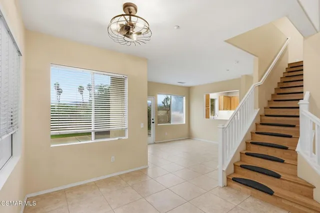 a view of a livingroom with wooden floor and windows