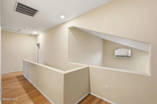 a view of storage and utility room with wooden floor