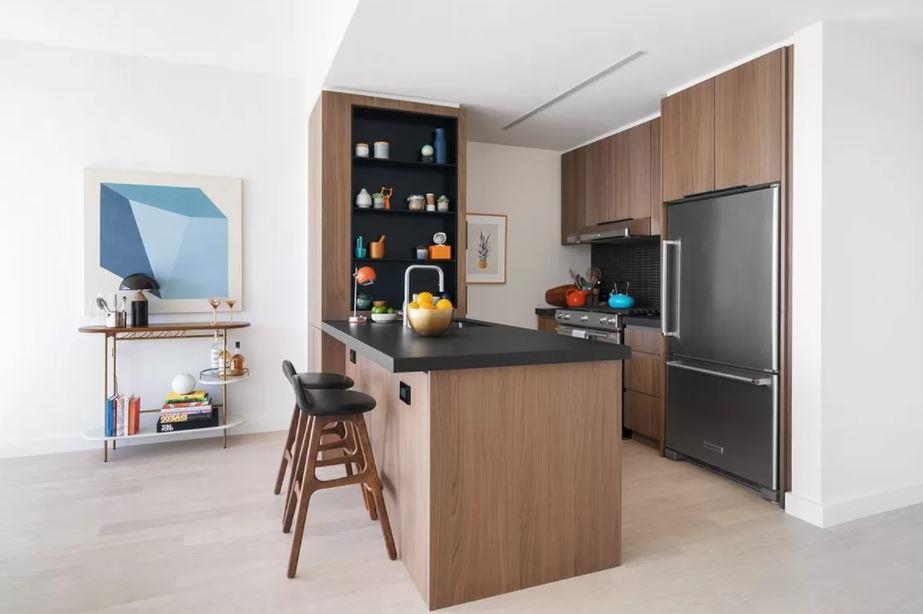 a kitchen with stainless steel appliances a refrigerator and a wooden floor