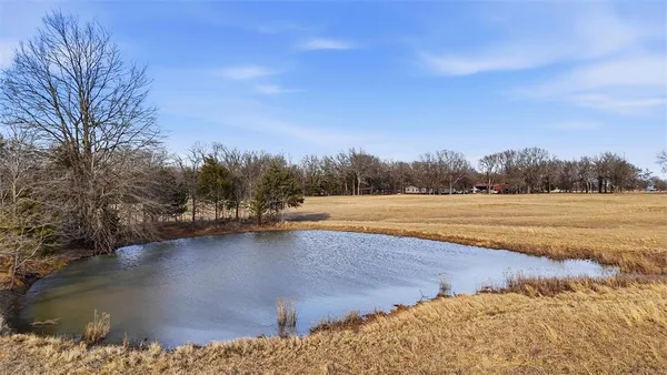 a view of a lake with trees in the background