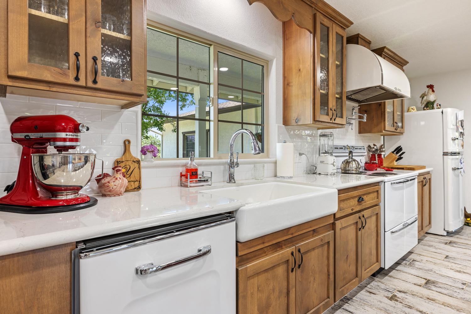 4742 Crow Road Oakdale, CA 95361 - Photo 16 of 95 a kitchen with stainless steel appliances granite countertop a sink dishwasher and cabinets with wooden floor
