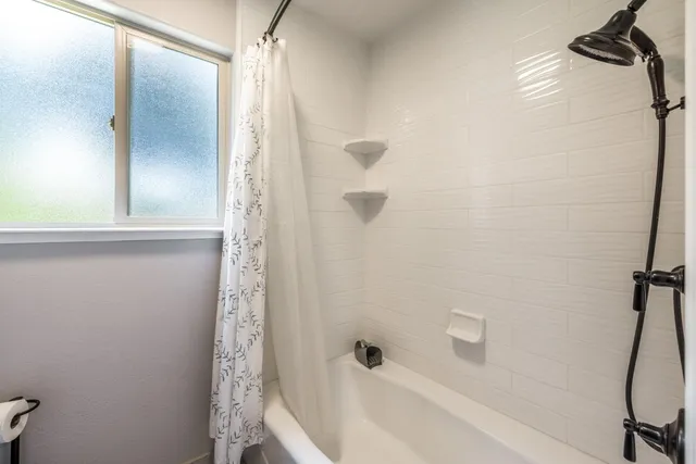 a view of a house with a yard and potted plants