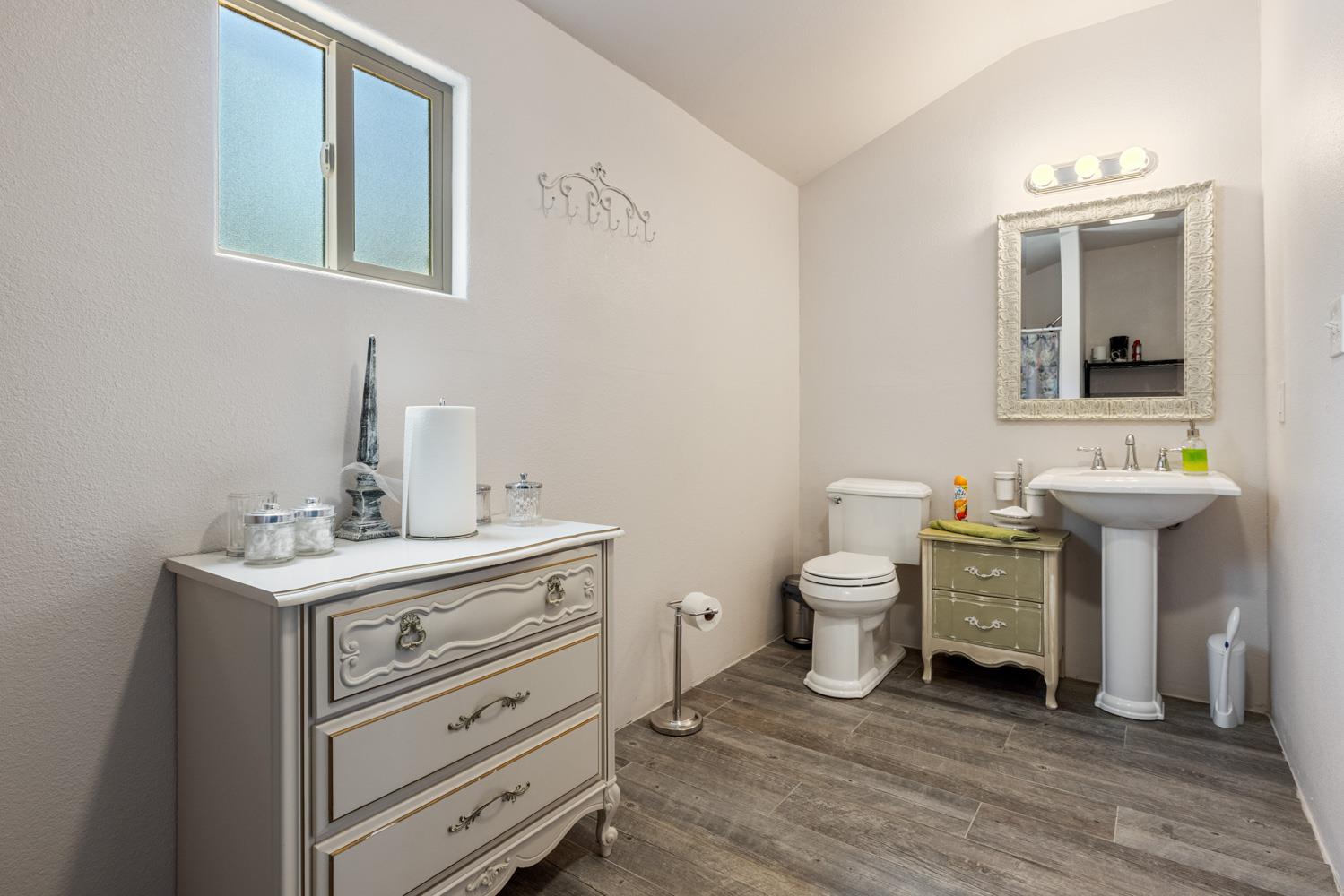 4742 Crow Road Oakdale, CA 95361 - Photo 52 of 95 a bathroom with a toilet a sink and mirror