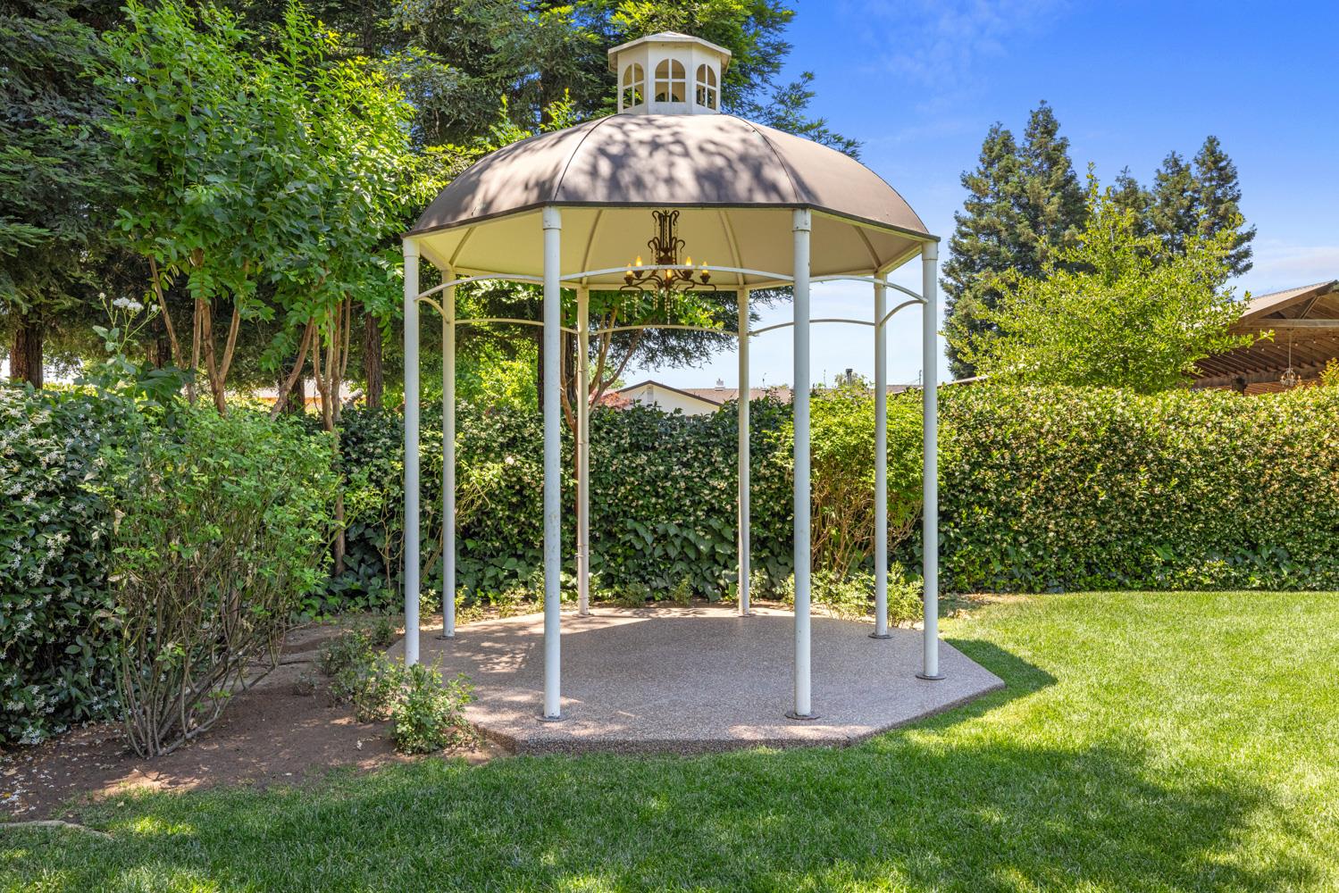 4742 Crow Road Oakdale, CA 95361 - Photo 56 of 95 a view of a garden with a bench and trees