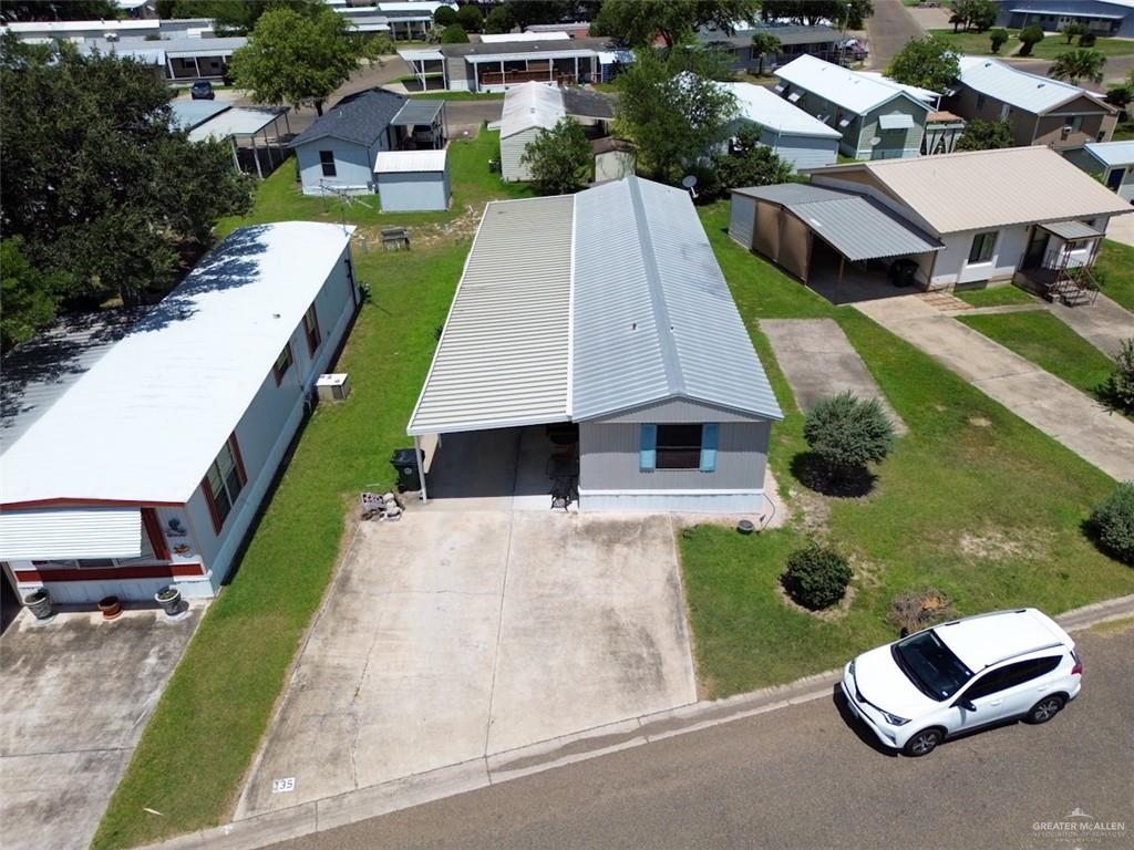 an aerial view of a house with swimming pool patio and yard
