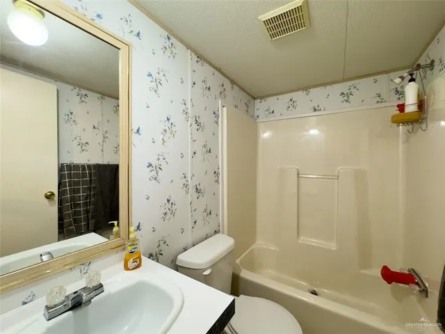 a bathroom with a sink mirror toilet and bathtub