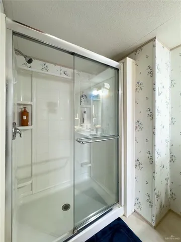 a bathroom with a glass shower door