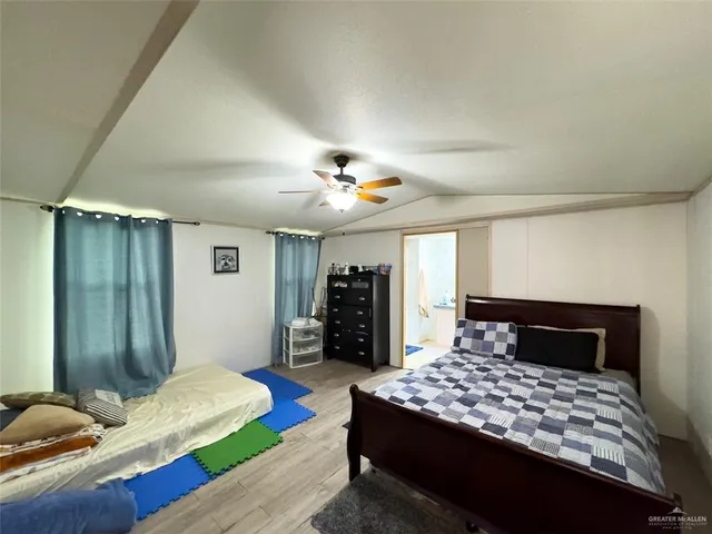 a bedroom with a large bed and a chandelier