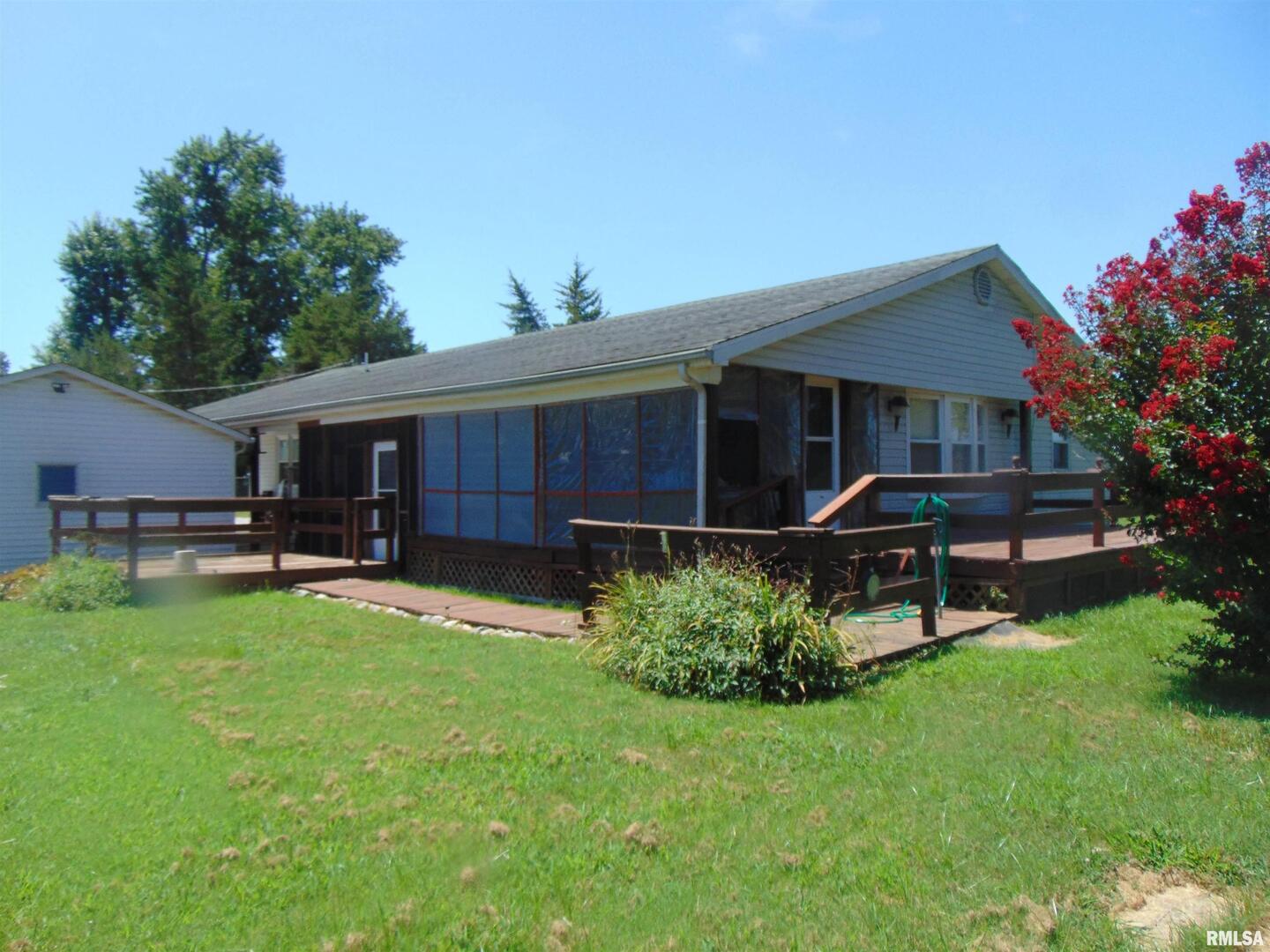 a house view with a sitting space and garden