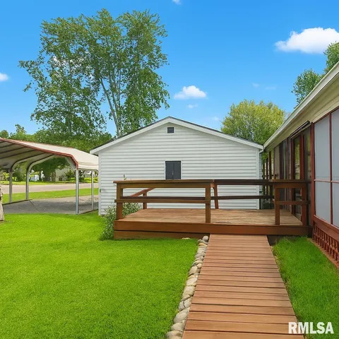 a view of a house with a yard and sitting area