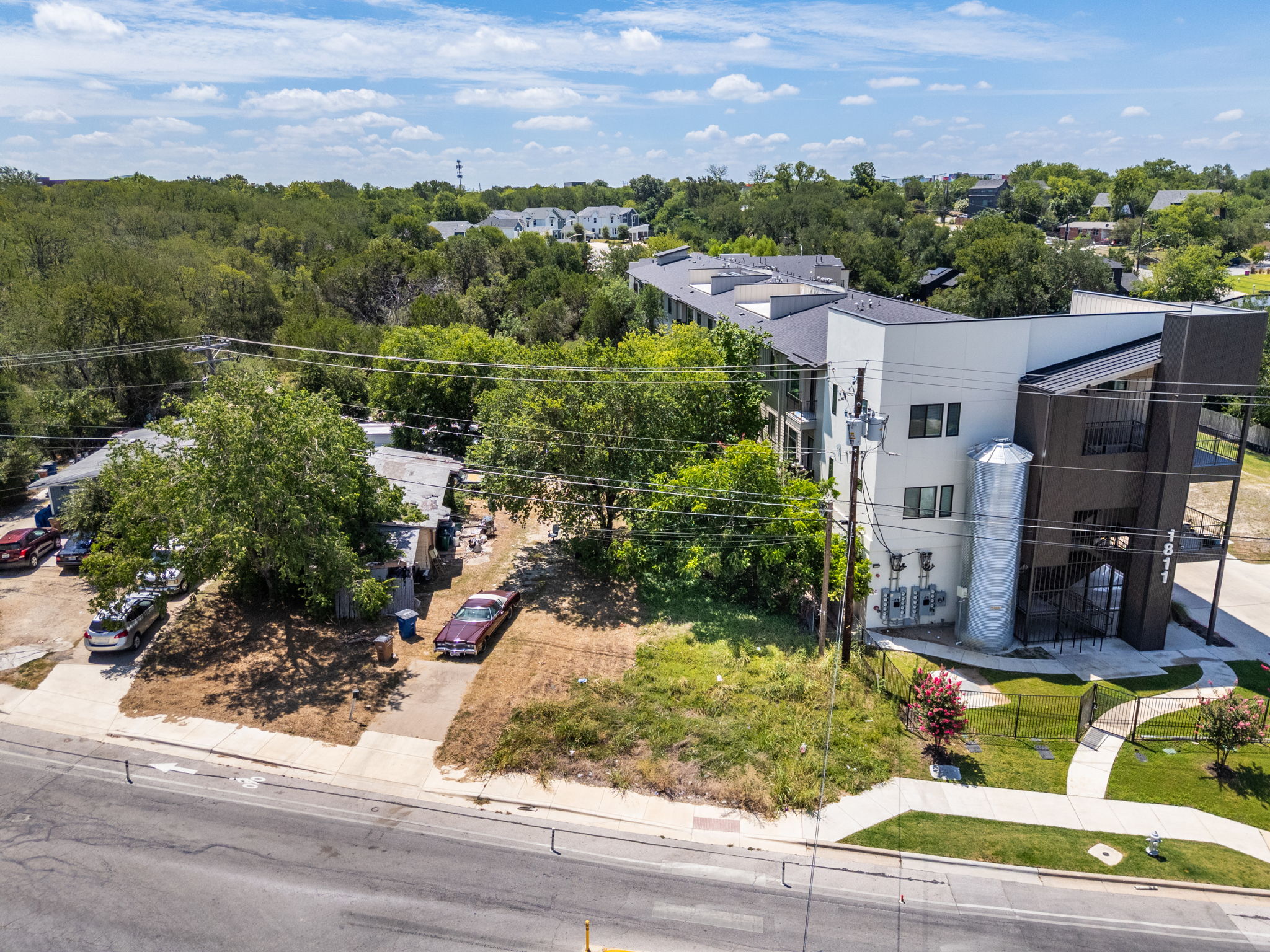 1813 Webberville Road Austin, TX 78721 - Photo 10 of 20 An aerial perspective reveals a contemporary multi-story structure with private balconies and manicured landscaping.
