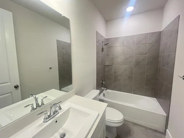 a bathroom with a sink a toilet and a bathtub