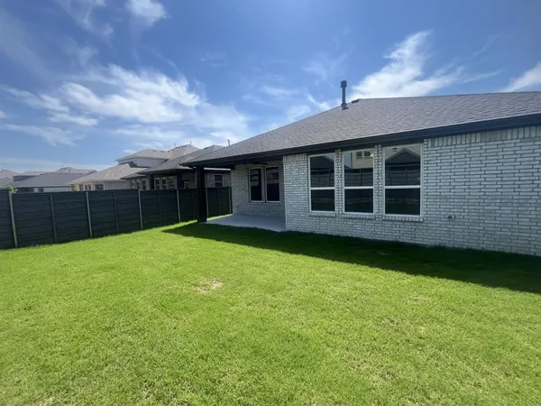 a view of a house with backyard and porch