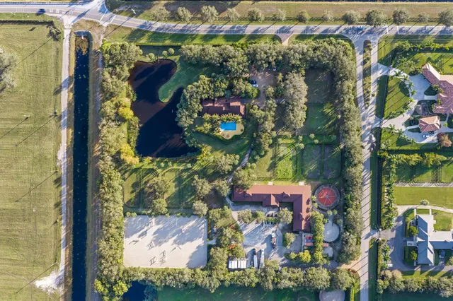 a dining room with furniture a rug and a large window