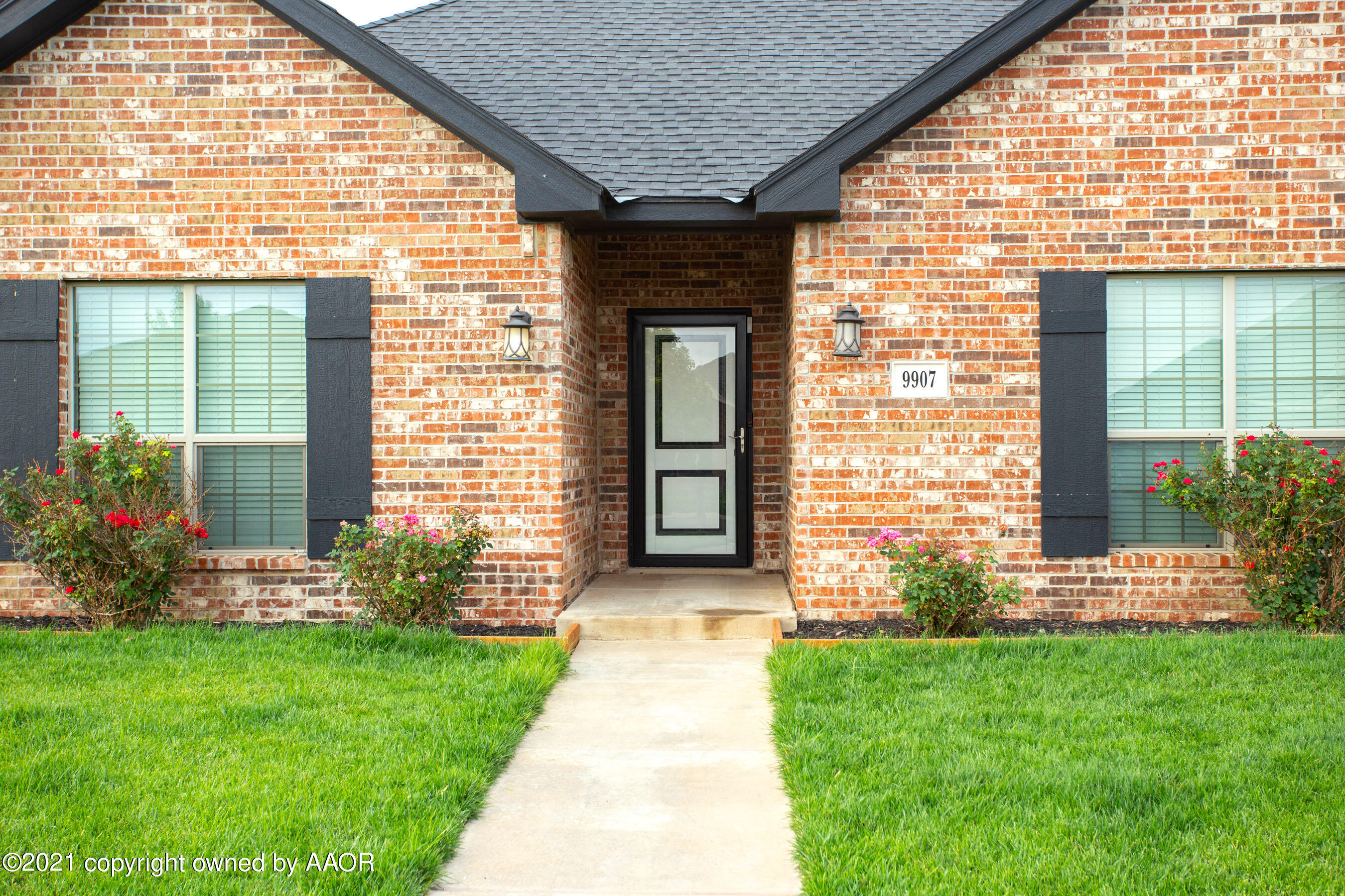 9907 Asher Avenue Amarillo, TX 79119 - Photo 2 of 24 a front view of a house with a garden