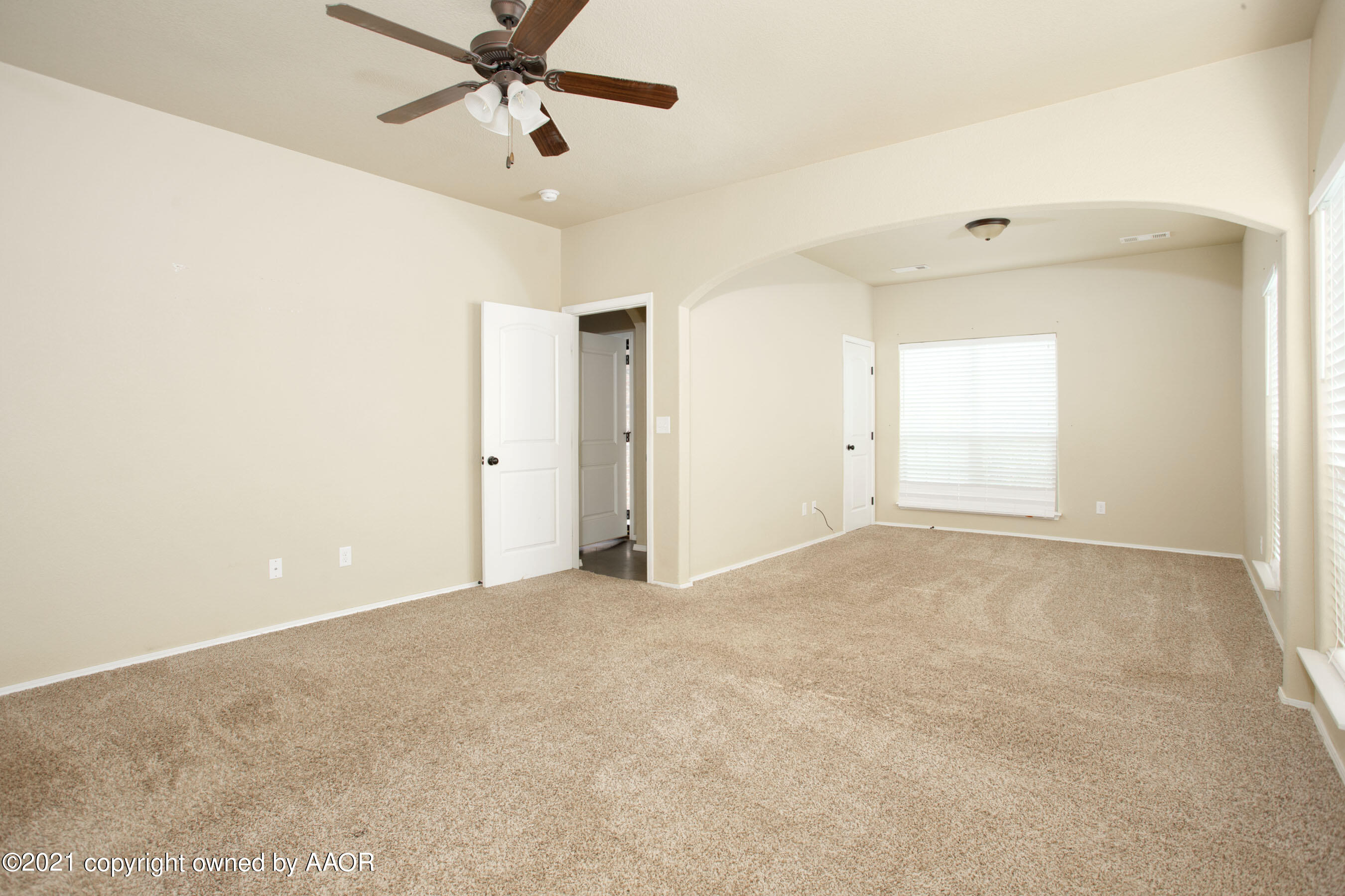 9907 Asher Avenue Amarillo, TX 79119 - Photo 11 of 24 an empty room with chandelier fan and windows