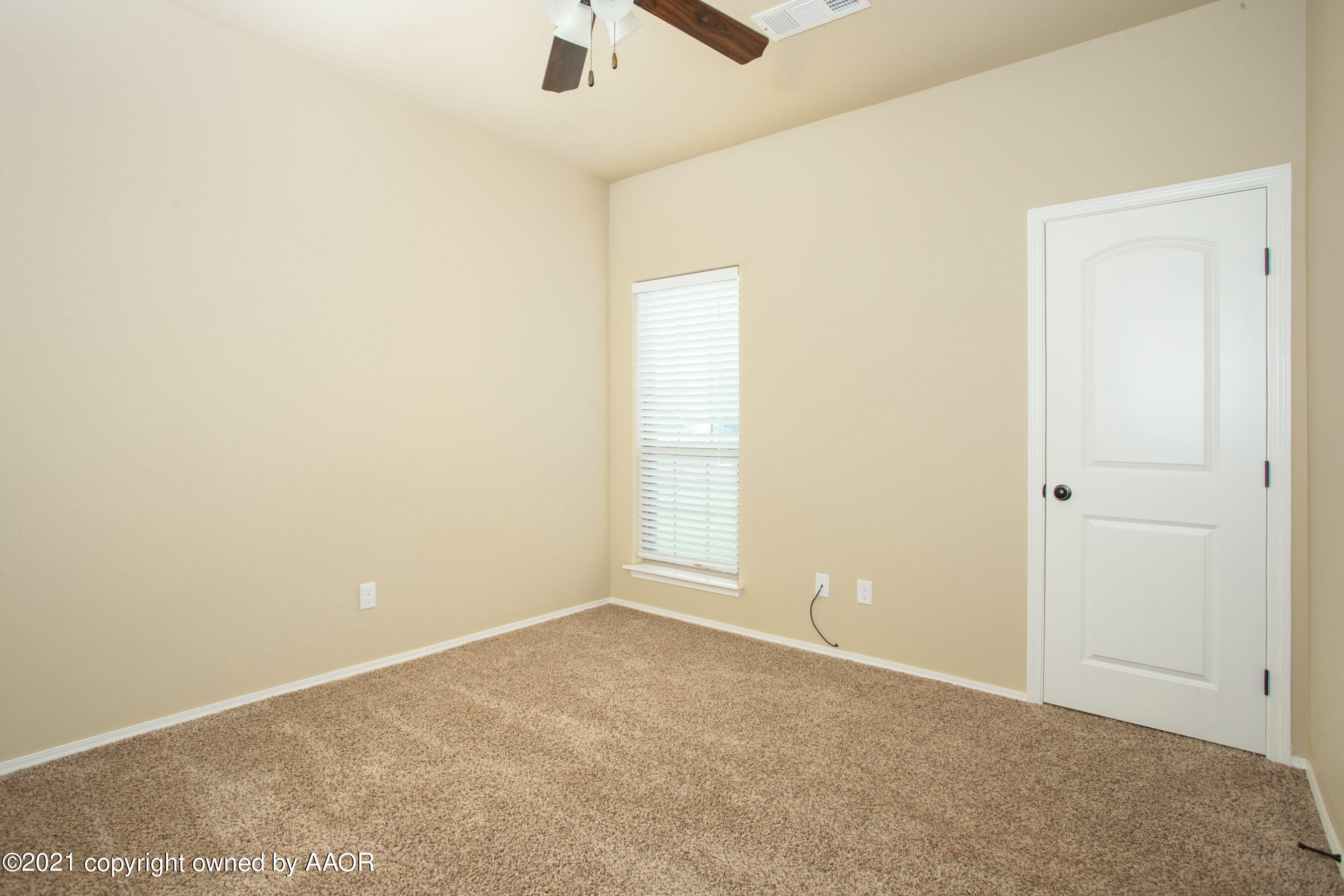 9907 Asher Avenue Amarillo, TX 79119 - Photo 18 of 24 an empty room with a window and a ceiling fan