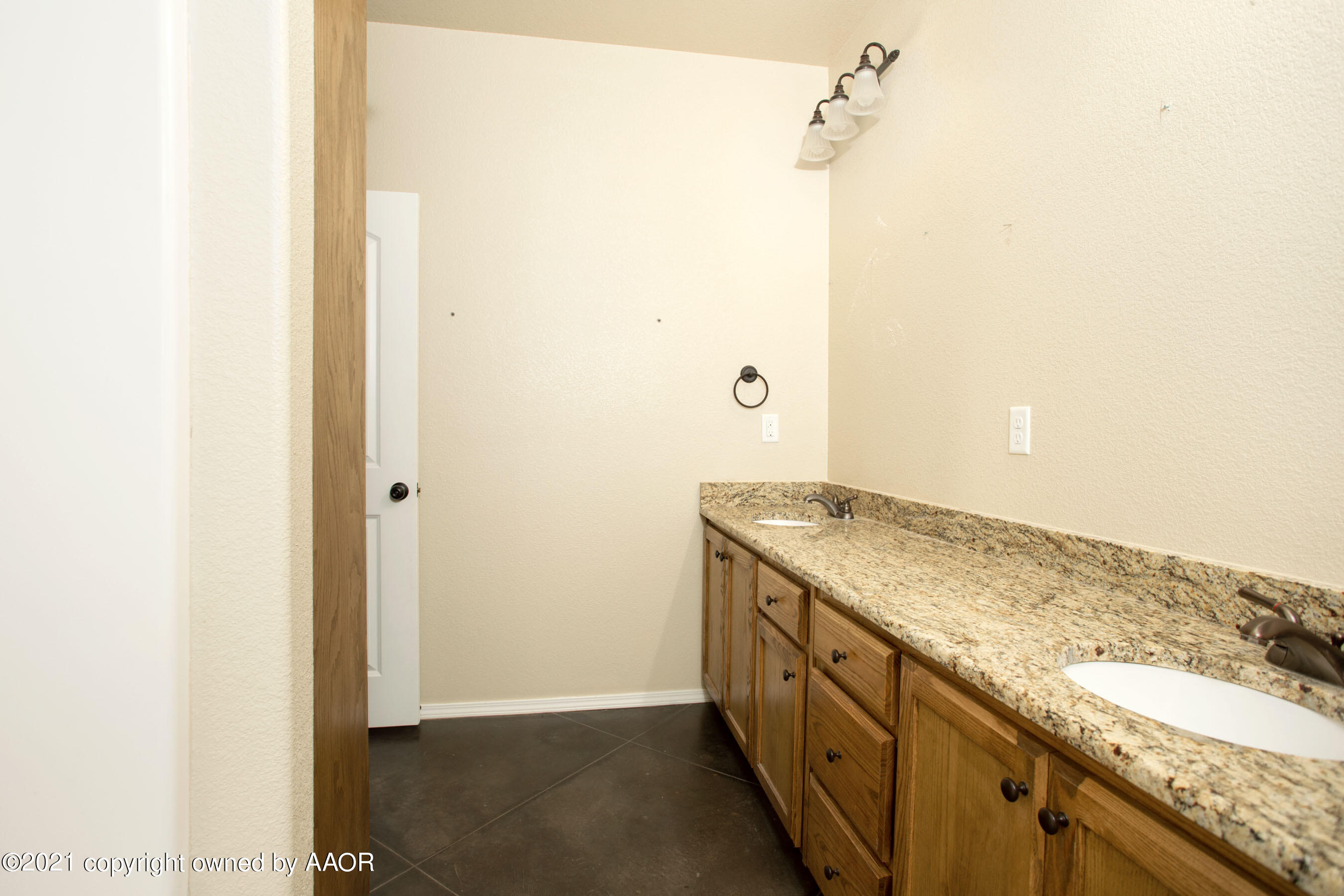 9907 Asher Avenue Amarillo, TX 79119 - Photo 20 of 24 a bathroom with a granite countertop sink and a mirror
