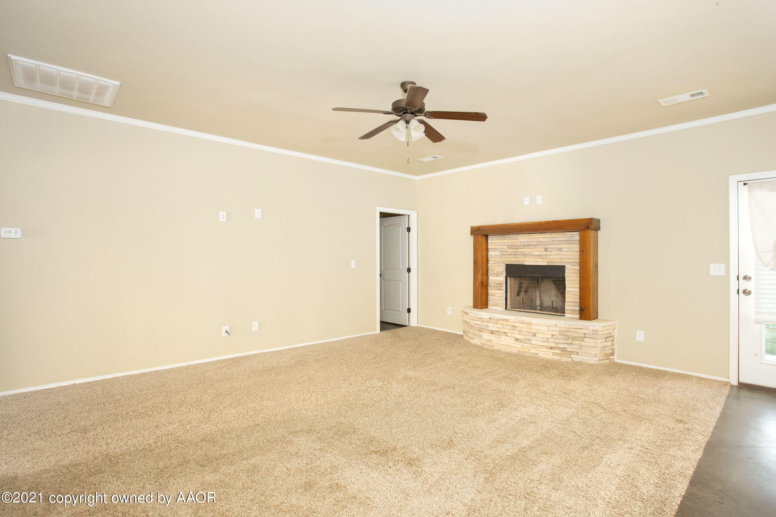 9907 Asher Avenue Amarillo, TX 79119 - Photo 5 of 24 a view of an empty room with a fireplace
