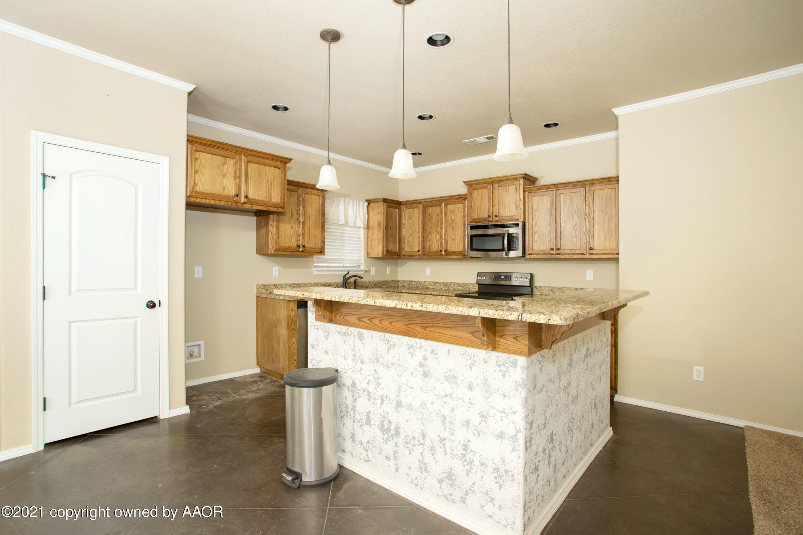 9907 Asher Avenue Amarillo, TX 79119 - Photo 8 of 24 a kitchen with stainless steel appliances granite countertop a sink a stove and a refrigerator