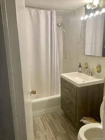 a bathroom with a sink mirror vanity and toilet