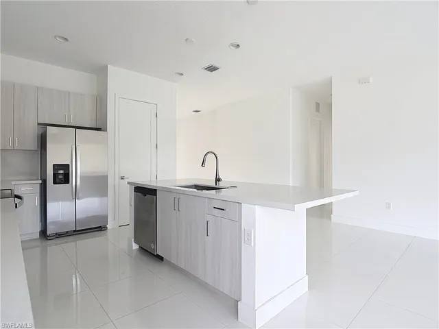 a kitchen with a sink and refrigerator