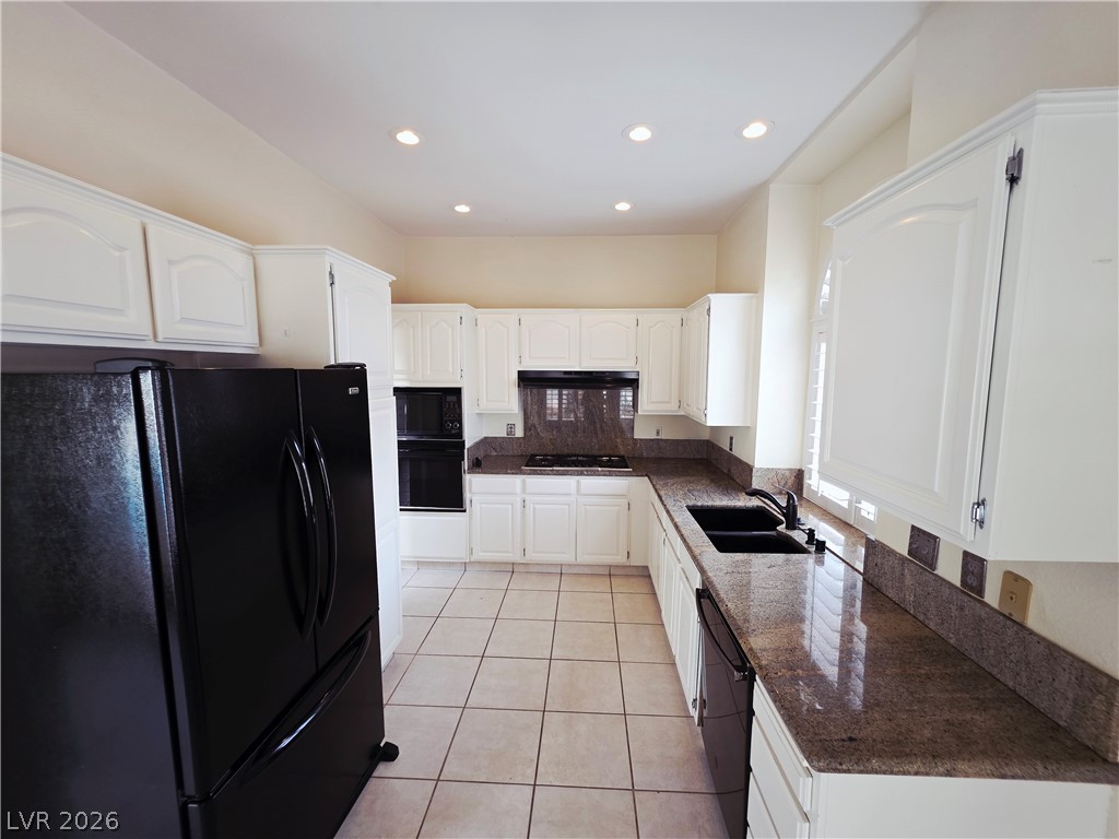 2920 Setting Sun Street Las Vegas, NV 89117 - Photo 16 of 43 This spacious kitchen offers ample cabinetry, modern appliances, and durable granite countertops for everyday living.