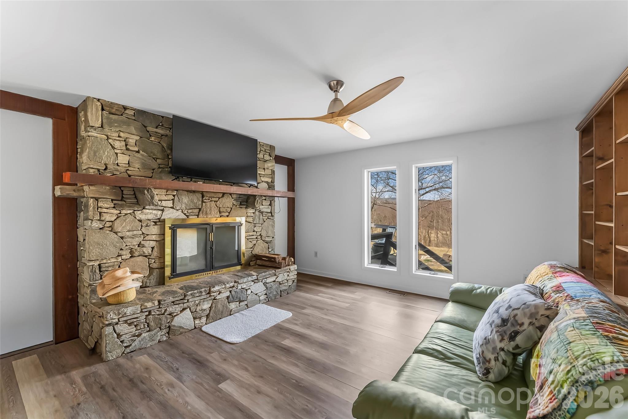 2590 Airport Road Marion, NC 28752 - Photo 15 of 48 a living room with furniture a flat screen tv and a fireplace
