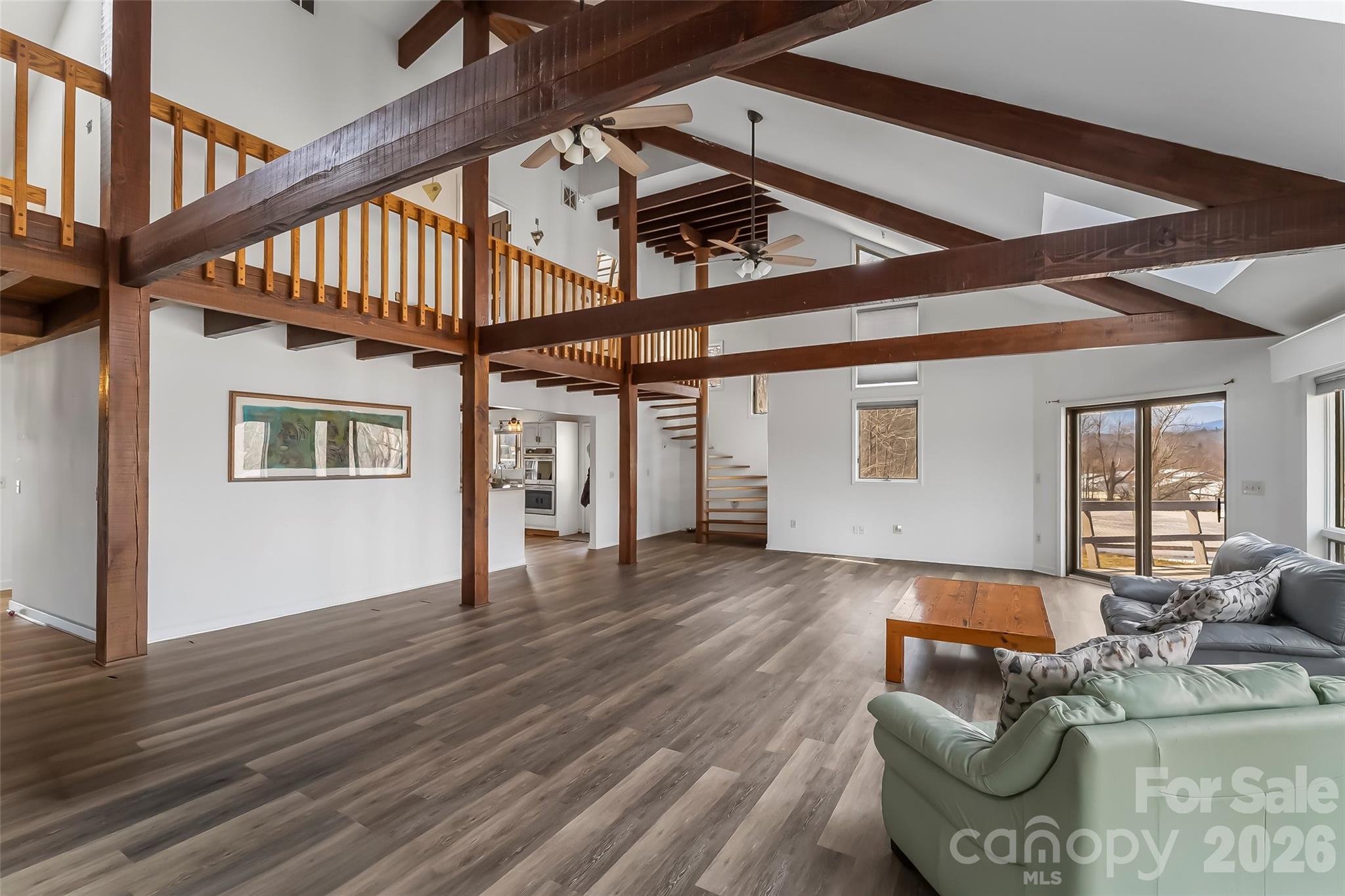 2590 Airport Road Marion, NC 28752 - Photo 9 of 48 a view of a livingroom with furniture staircase and windows