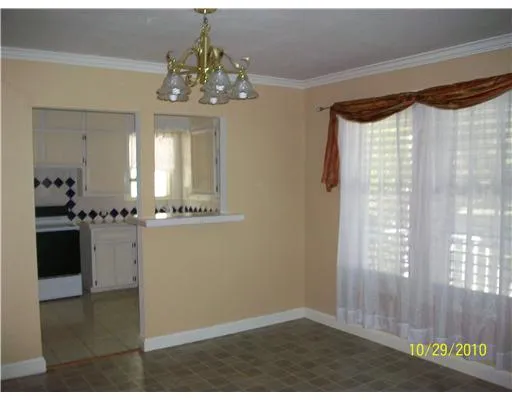 a view of a hallway to a bedroom and a window