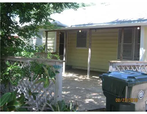 a backyard of a house with yard and outdoor seating