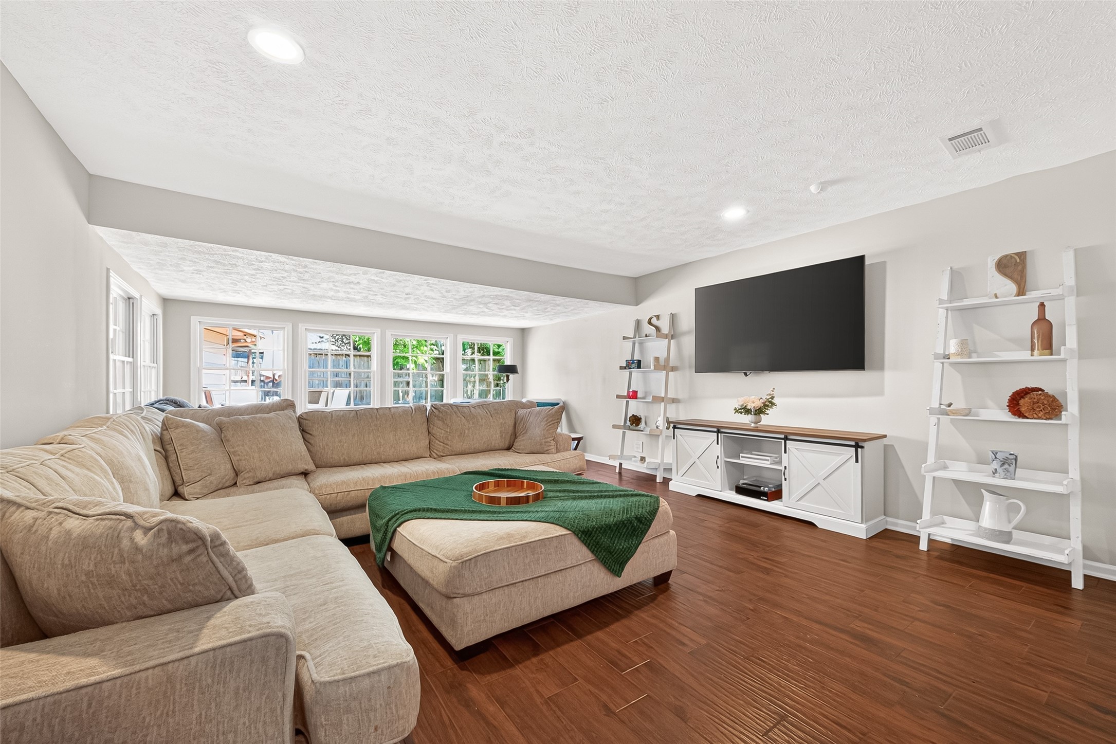 2610 Teague Road Houston, TX 77080 - Photo 6 of 49 Spacious family room featuring a stunning wall of windows that fills the space with abundant natural light and offers an open, airy feel ideal for relaxing or gathering with family and friends.