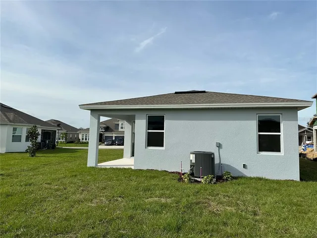 a backyard of a house with yard and barbeque oven