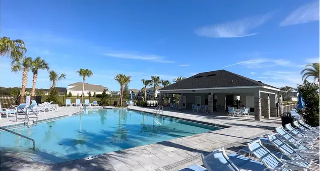 a view of a swimming pool with outdoor seating