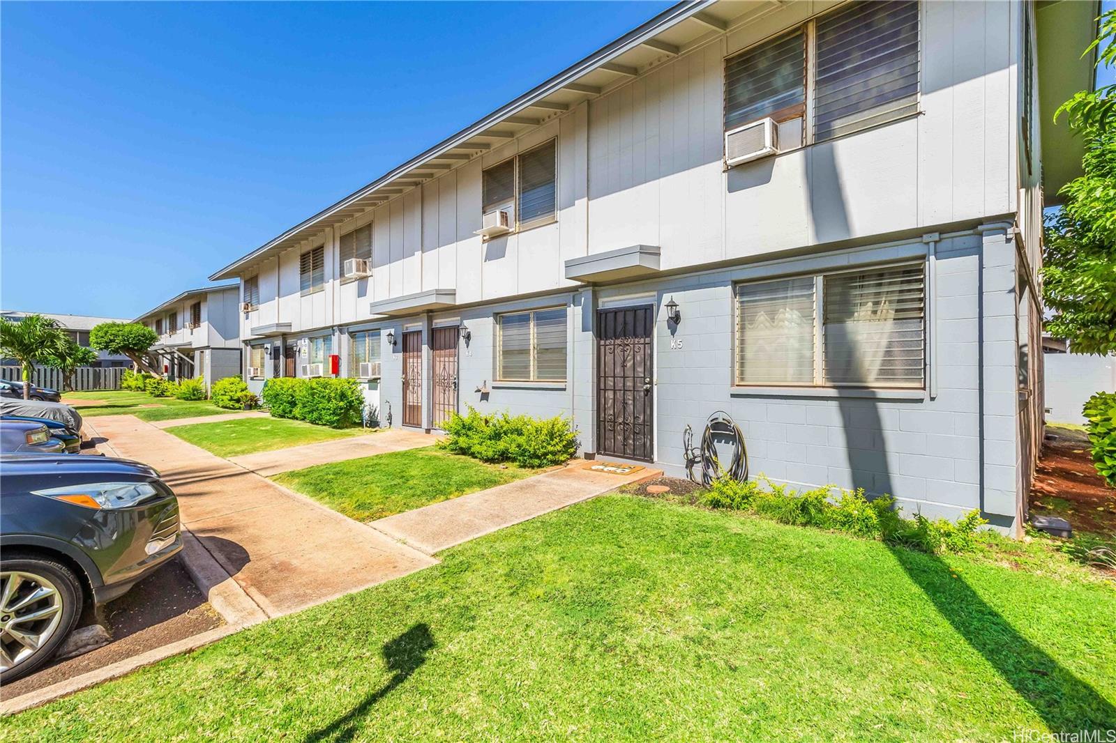91-926 Kulana Court, Unit K4 Ewa Beach, HI 96706 - Photo 1 of 1 a front view of a house with garden