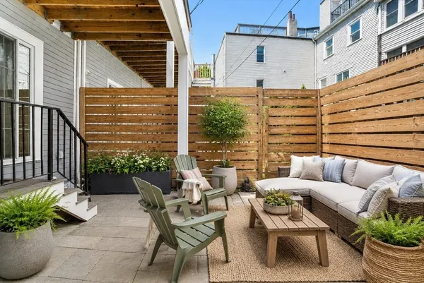 a view of a patio with couches chairs and potted plants