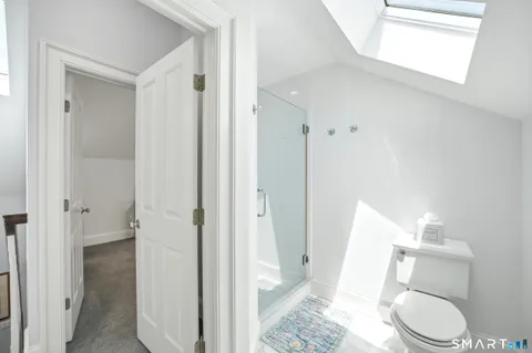 a bathroom with a toilet and a shower