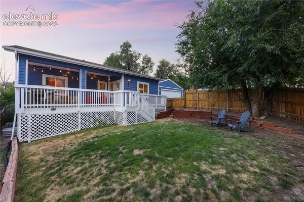 a view of a house with a patio and a yard