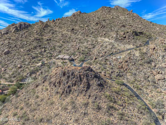 a view of a large building with mountains in the background