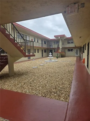 a view of a big room with wooden floor and a rug