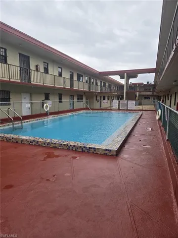 a view of swimming pool with outdoor seating and plants