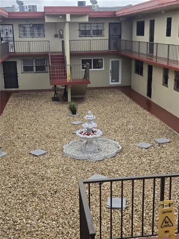 a backyard of a house with table and chairs