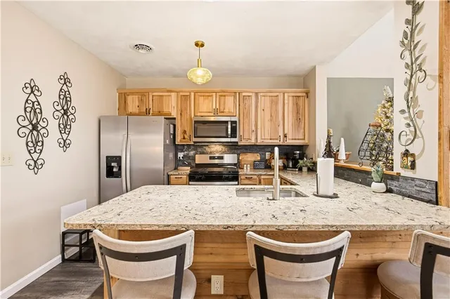 a kitchen with a stove a sink and a microwave