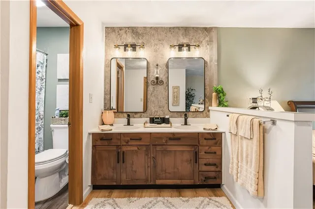 a bathroom with a double vanity sink mirror and double