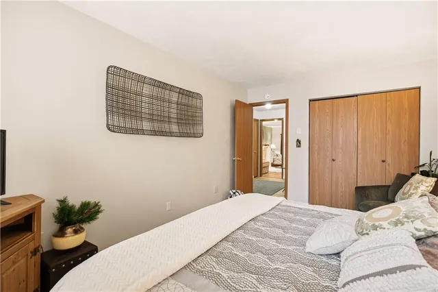 a bedroom with a bed and flat screen tv